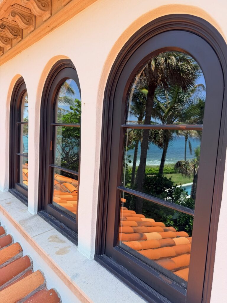 Clear arched windows with ocean view after glass restoration in Jupiter, FL