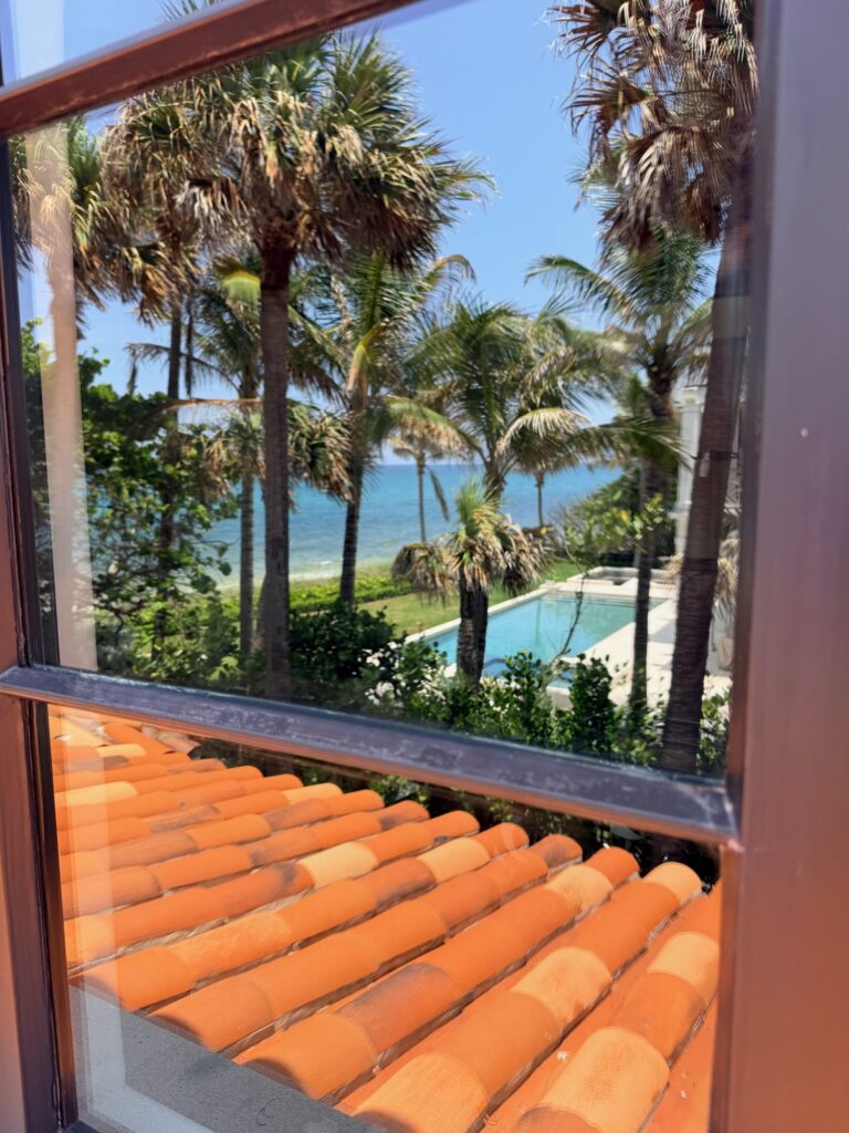 Clear window overlooking the pool and ocean after glass restoration in Jupiter, FL